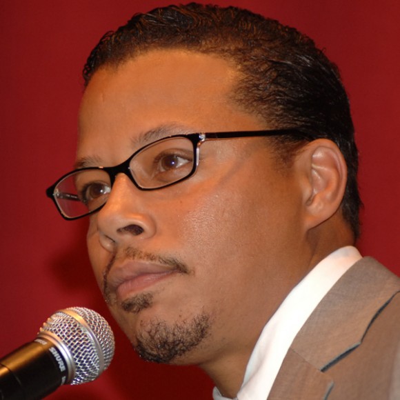 Actor Terrence Howard holds a microphone on the JBFC stage