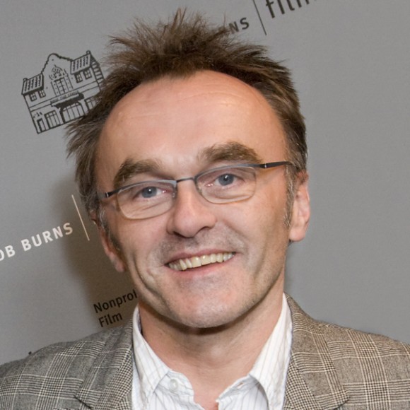 Filmmaker Danny Boyle in front of a step-and-repeat backdrop at the JBFC Theater