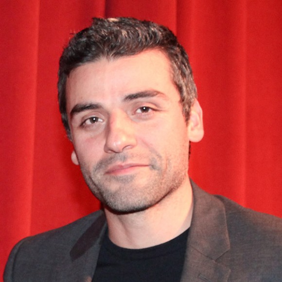 Oscar Isaac standing onstage at the JBFC