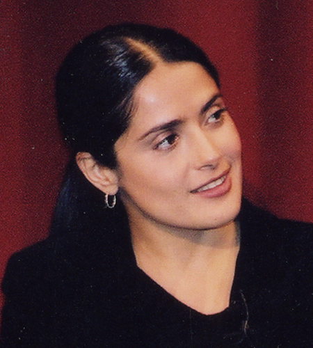 Salma Hayek smiling with head turned in front of red background