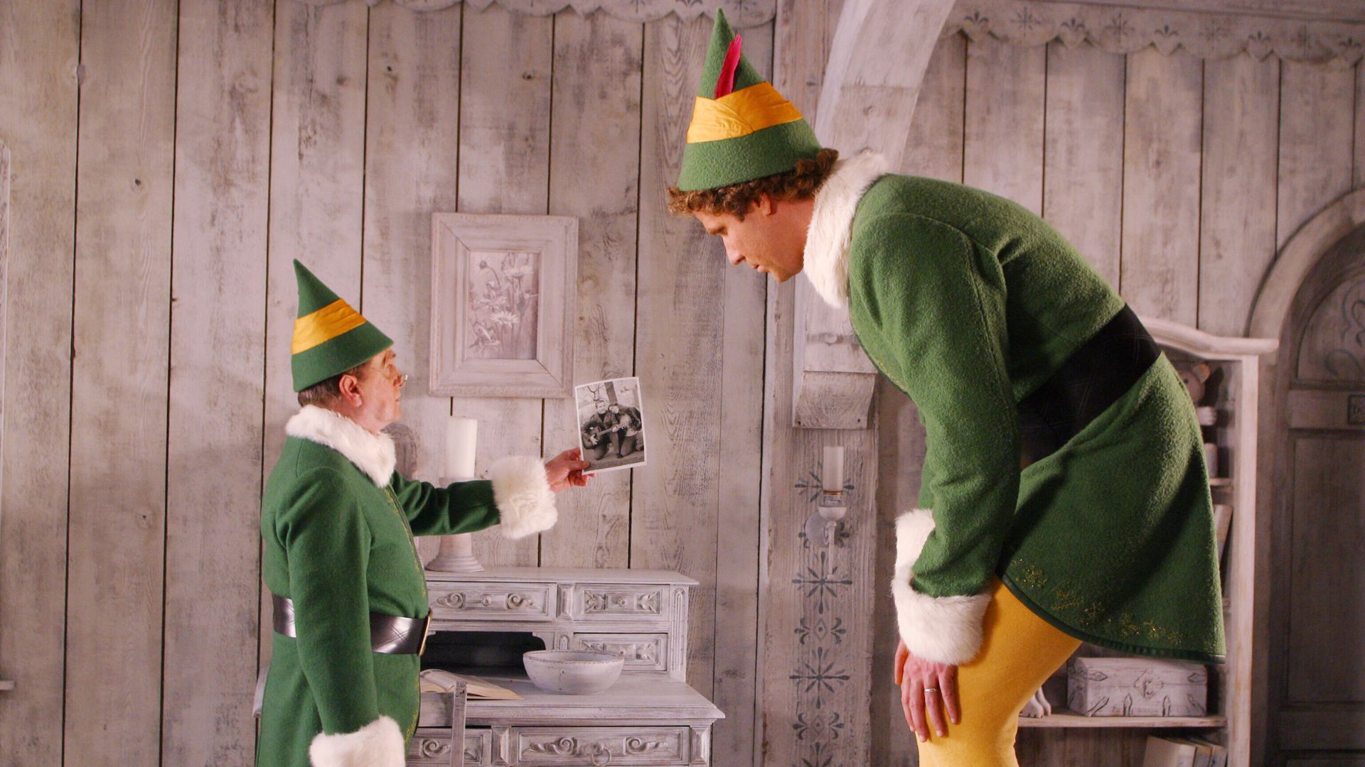 A small elf stands next to a large elf in the movie Elf